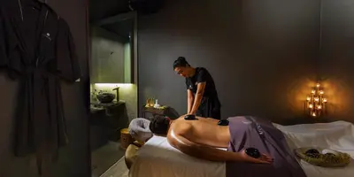 a woman giving a man a bath in a bed at Baan Laimai Beach Resort & Spa - SHA Extra Plus in Patong Beach