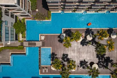 an overhead view of a swimming pool with palm trees at Baan Laimai Beach Resort & Spa - SHA Extra Plus in Patong Beach