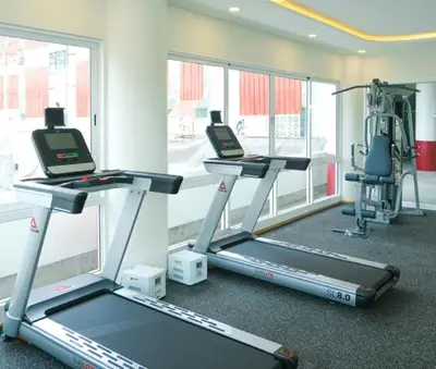 a gym with two treadmills and a treadmill at Hotel Midtown Ratsada in Phuket Town