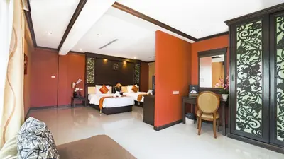 a hotel room with a bed and a desk at Aonang Orchid Resort in Ao Nang Beach