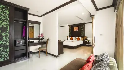 a hotel room with a bed and a desk at Aonang Orchid Resort in Ao Nang Beach
