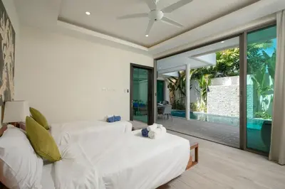 two white beds in a room with a patio at VILLA BAWAL 4BR Private pool villa in Rawai Beach