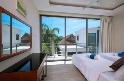a bedroom with a tv and a large window at VILLA BAWAL 4BR Private pool villa in Rawai Beach