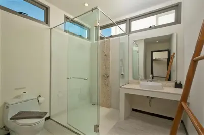 a bathroom with a shower and a toilet and a sink at VILLA BAWAL 4BR Private pool villa in Rawai Beach