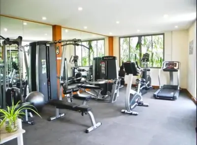 a gym with several treadmills and machines in a room at VILLA BAWAL 4BR Private pool villa in Rawai Beach