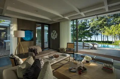 a living room with a couch and a table at Rosewood Phuket in Patong Beach