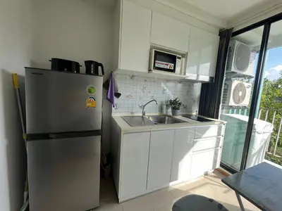 a small kitchen with a refrigerator and a sink at 1 bedroom Centrio Condominium Phuket Near Central Festival in Phuket town in Phuket Town
