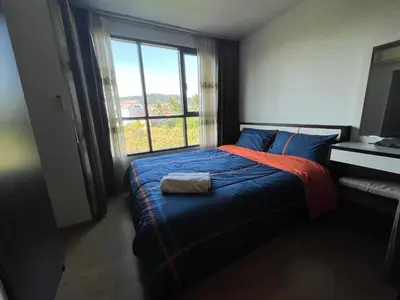 a bedroom with a bed with a large window at 1 bedroom Centrio Condominium Phuket Near Central Festival in Phuket town in Phuket Town