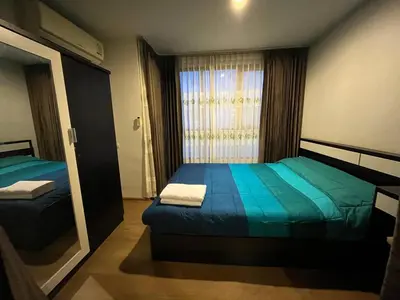 a small bedroom with two beds and a window at 1 bedroom Centrio Condominium Phuket Near Central Festival in Phuket town in Phuket Town