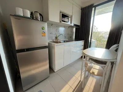 a kitchen with a stainless steel refrigerator and a sink at 1 bedroom Centrio Condominium Phuket Near Central Festival in Phuket town in Phuket Town