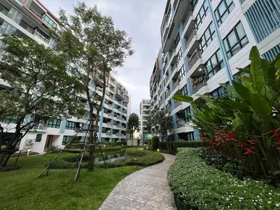 a walkway in an apartment complex with buildings at 1 bedroom Centrio Condominium Phuket Near Central Festival in Phuket town in Phuket Town