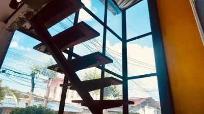a glass window with a view of a street at The Endless Bangtao Residence 1987 in Bang Tao Beach