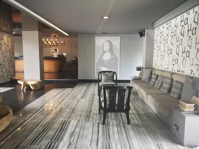a living room with a couch and a table at Mazi Design Hotel by Kalima in Patong Beach