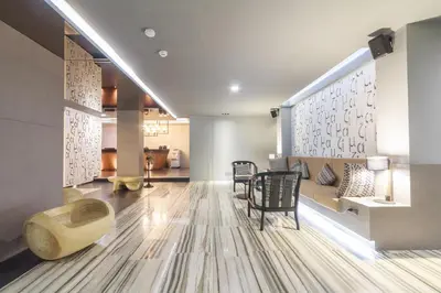 a living room with a couch and a table at Mazi Design Hotel by Kalima in Patong Beach