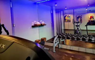 a room with chairs and a stage with purple lights at Mazi Design Hotel by Kalima in Patong Beach