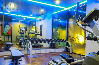 a gym with cardio equipment in a room at Mazi Design Hotel by Kalima in Patong Beach
