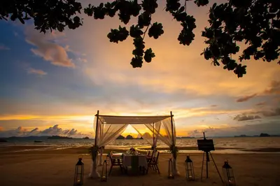 a wedding ceremony on the beach at sunset at Tup Kaek Sunset Beach Resort-SHA Plus in Tab Kaek Beach
