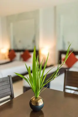 a plant in a vase sitting on top of a table at Krabi Aquamarine Resort - SHA Plus in Ao Nang Beach