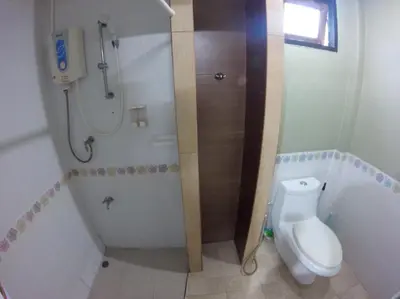 a small bathroom with a toilet and a shower at The Endless Bangtao Residence LOFT 8 in Bang Tao Beach