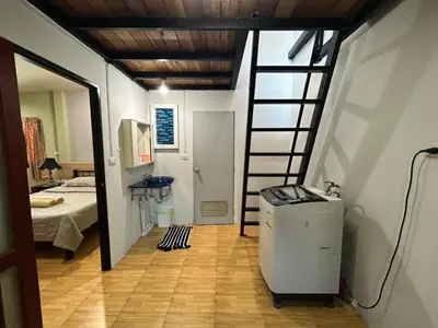 a room with a stairs leading to a bedroom at The Endless Bangtao Residence LOFT 8 in Bang Tao Beach