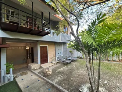 a house with a tree in front of it at The Endless Bangtao Residence LOFT 8 in Bang Tao Beach