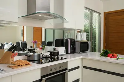 a kitchen with a stove and a counter top at VILLA RAJA 4BR Private pool villa in Rawai Beach