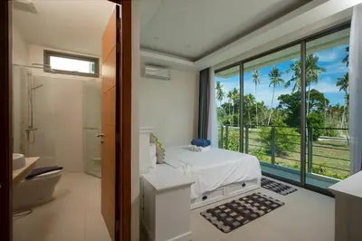 a bathroom with a bed and a view of the ocean at VILLA RAJA 4BR Private pool villa in Rawai Beach