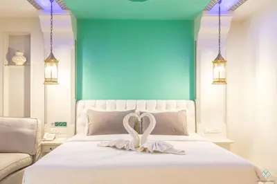 a bedroom with a white bed with a heart on it at The Verandah Aonang in Ao Nang Beach