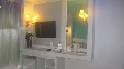 a bathroom with a vanity with a mirror and a tv at The Verandah Aonang in Ao Nang Beach