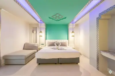 a bedroom with a bed and a chair in it at The Verandah Aonang in Ao Nang Beach