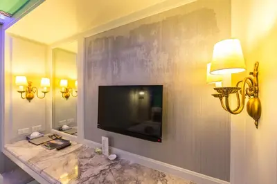 a living room with a flat screen tv on a wall at The Verandah Aonang in Ao Nang Beach