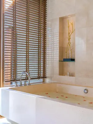 a large bath tub in a bathroom with a window at Renaissance Phuket Resort & Spa in Mai Khao Beach