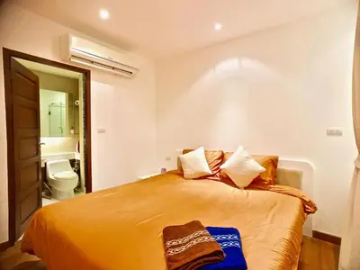 a bedroom with a bed and a bathroom with a toilet at Art Patong by Moloko in Patong Beach
