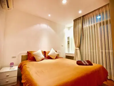 a bedroom with a large bed and a window at Art Patong by Moloko in Patong Beach