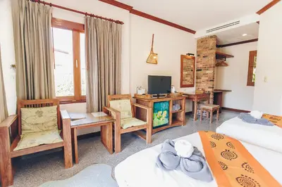 a hotel room with two beds and a desk at Krabi Sands Resort in Klong Muang Beach