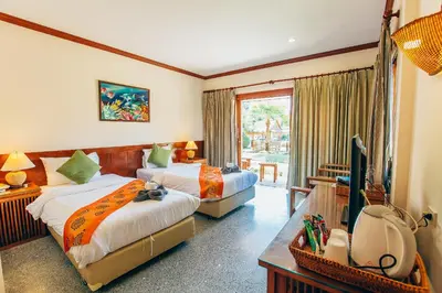 a hotel room with two beds and a television at Krabi Sands Resort in Klong Muang Beach