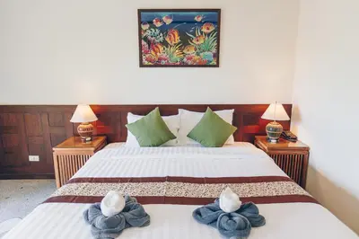 a bedroom with two beds with towels on them at Krabi Sands Resort in Klong Muang Beach