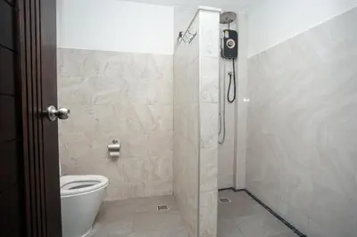a bathroom with a shower with a toilet at Baan Ban Dalay in Ao Nang Beach