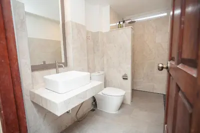 a bathroom with a white sink and a toilet at Baan Ban Dalay in Ao Nang Beach