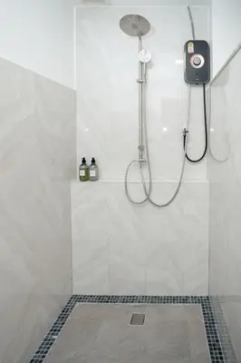 a bathroom with a shower with a phone in it at Baan Ban Dalay in Ao Nang Beach