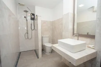 a bathroom with a sink and a shower and a toilet at Baan Ban Dalay in Ao Nang Beach