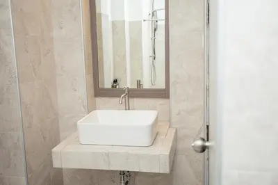a bathroom with a white sink and a mirror at Baan Ban Dalay in Ao Nang Beach