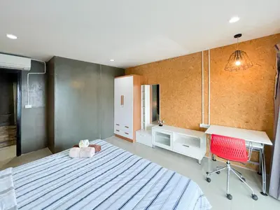 a bedroom with a bed and a desk and a chair at The Endless Bangtao Residence LOFT 9 in Bang Tao Beach