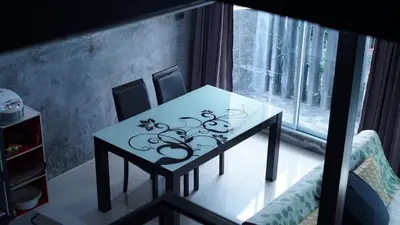 a small table in a room with a window at The Endless Bangtao Residence LOFT 9 in Bang Tao Beach