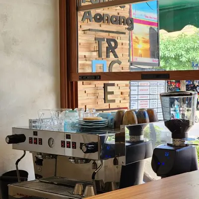 a coffee making machine in a restaurant with a counter at The Palace Aonang Resort in Ao Nang Beach