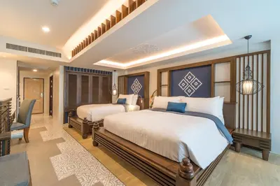 a bedroom with two beds and a dining room at Aonang Princeville Villa Resort & Spa - GHA WellHotel-Halal Certified, Krabi, Thailand in Ao Nang Beach