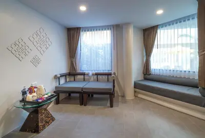 a living room with a bench and a window at Aonang Princeville Villa Resort & Spa - GHA WellHotel-Halal Certified, Krabi, Thailand in Ao Nang Beach