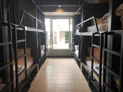 a room with multiple bunk beds in a room at Aonang Sunset Hotel - SHA Extra Plus in Ao Nang Beach