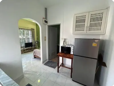 a kitchen with a refrigerator and a table at The Endless Bangtao Residence TV2 AND TV 3 in Bang Tao Beach