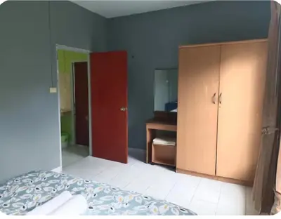 a bedroom with a bed and a red cabinet at The Endless Bangtao Residence TV2 AND TV 3 in Bang Tao Beach